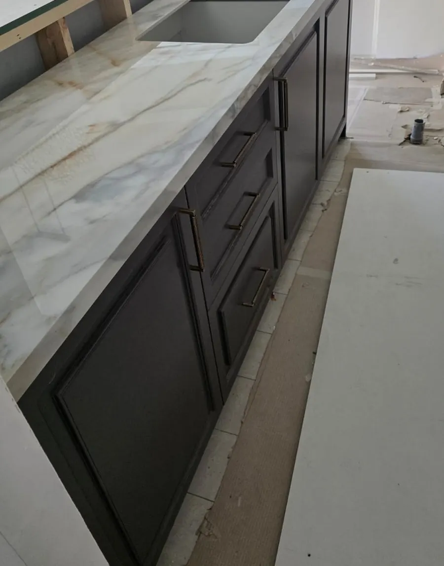 Charcoal panelled kitchen run with the marble-look worktop fitted