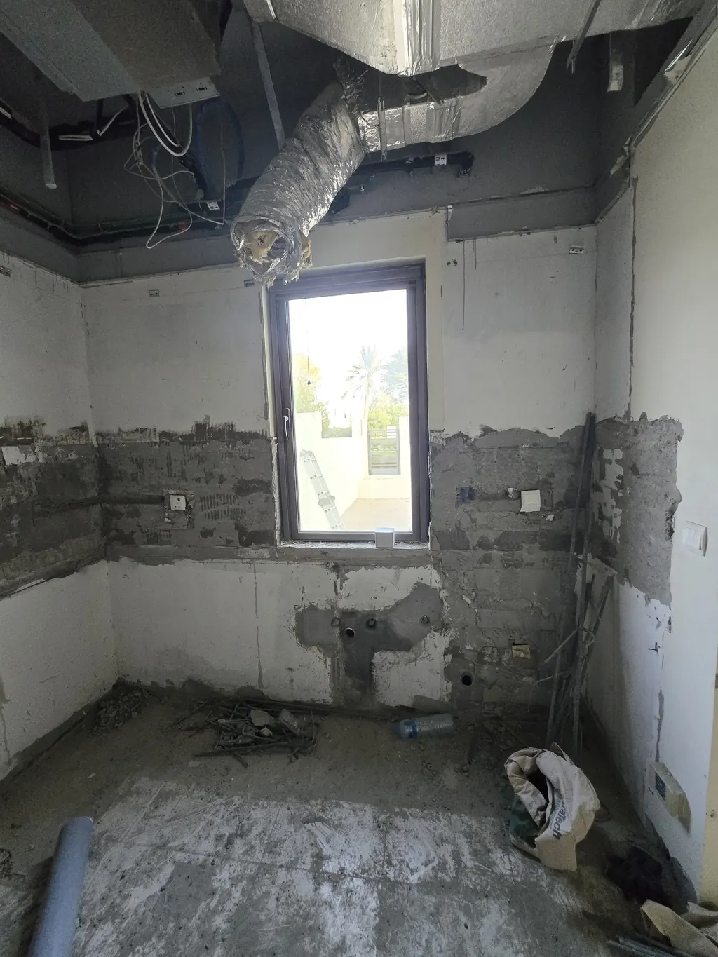 A bathroom stripped back to the blockwork, old tiles and fittings removed